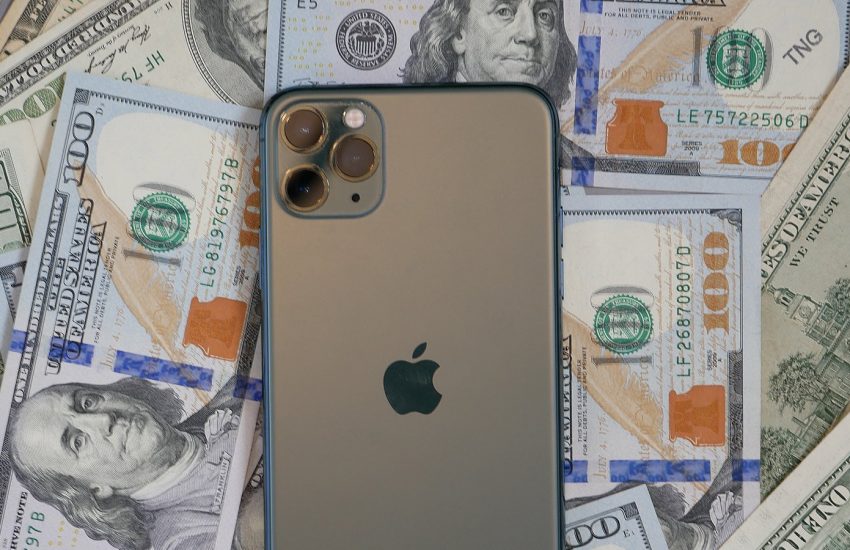 iPhone 12 with dollar bills