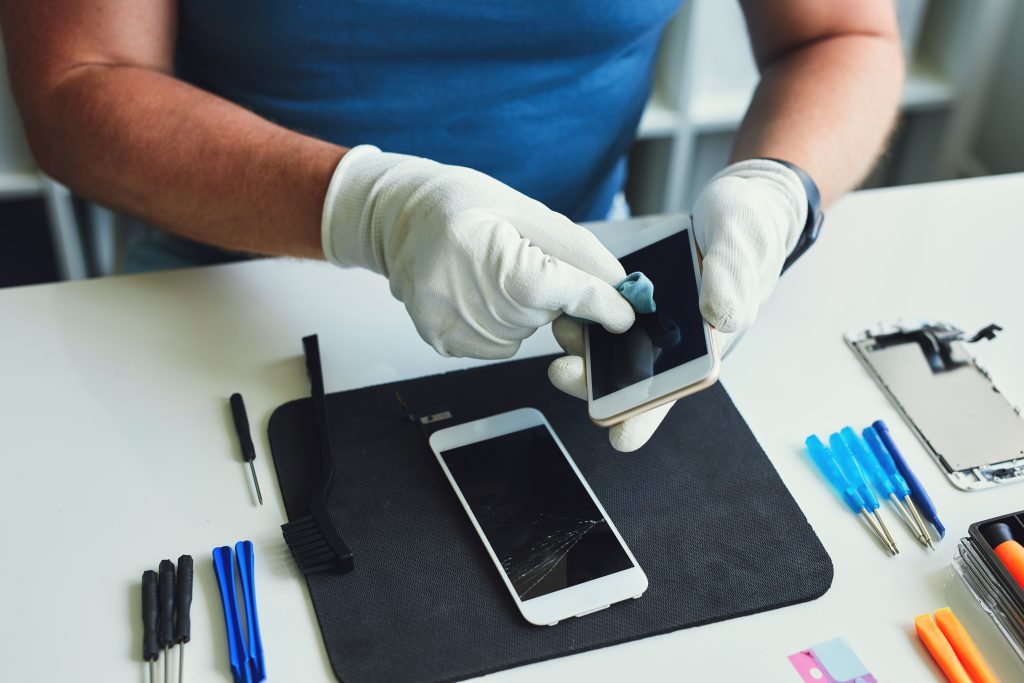 repair technician removing water from a phone