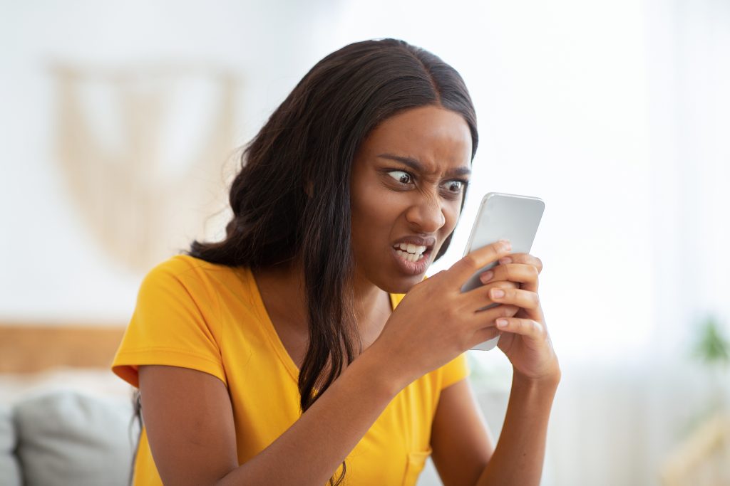 Angry lady looking at partners phone